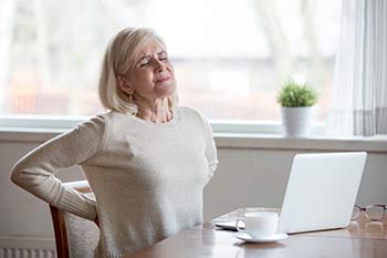 Woman suffering from chronic back pain