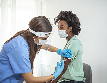 A woman receives a Covid-19 Vaccination