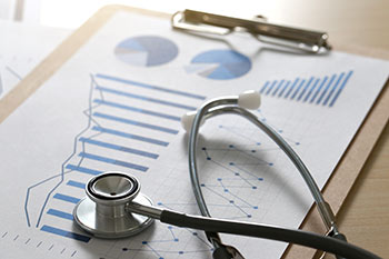 Graphs and charts along side a stethoscope 